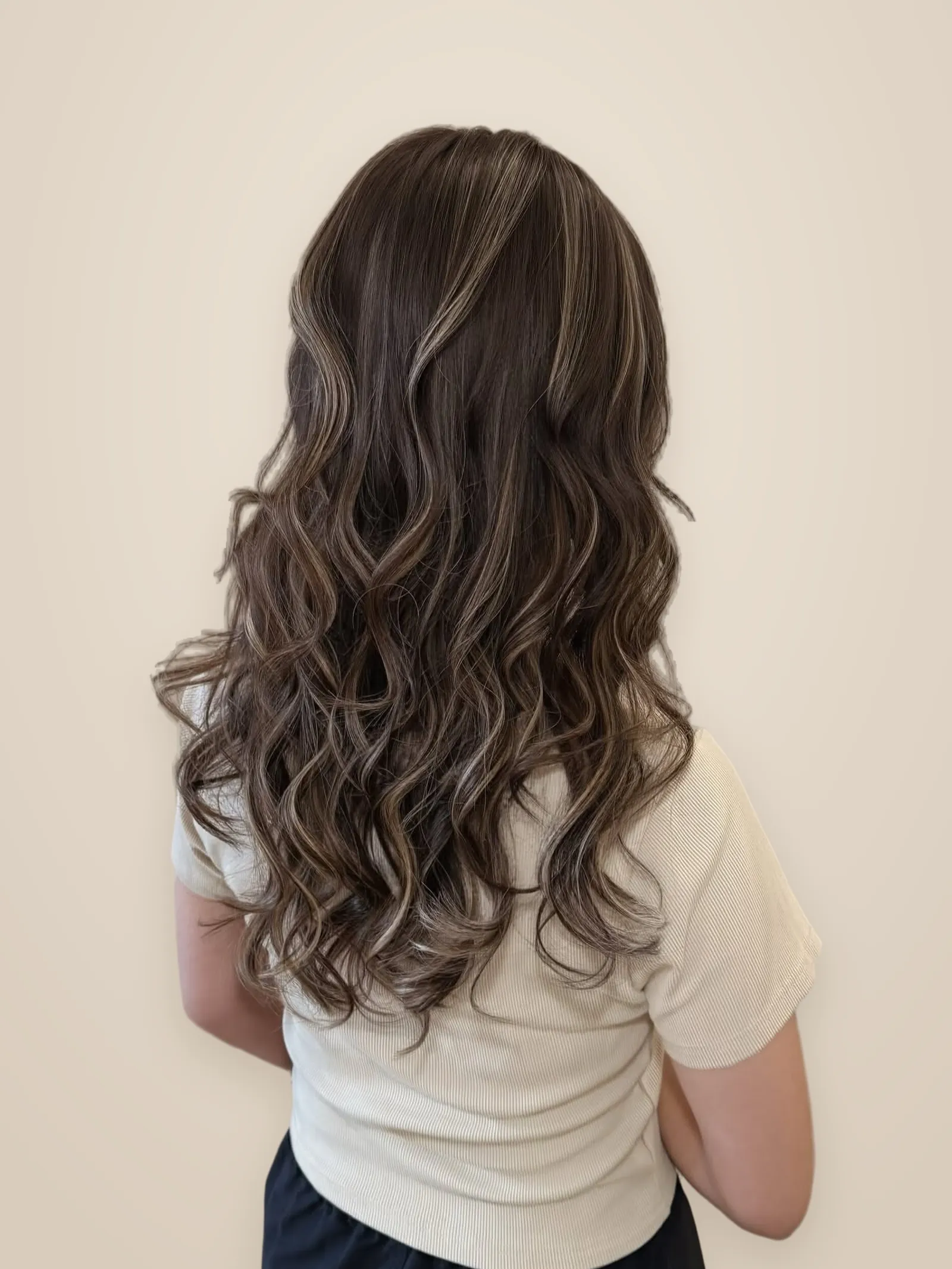 Back view of long soft waves in espresso brown with ash-blonde ribbon highlights
